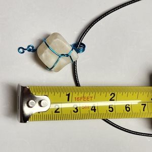Handmade wire wrap stone pendant with cord.